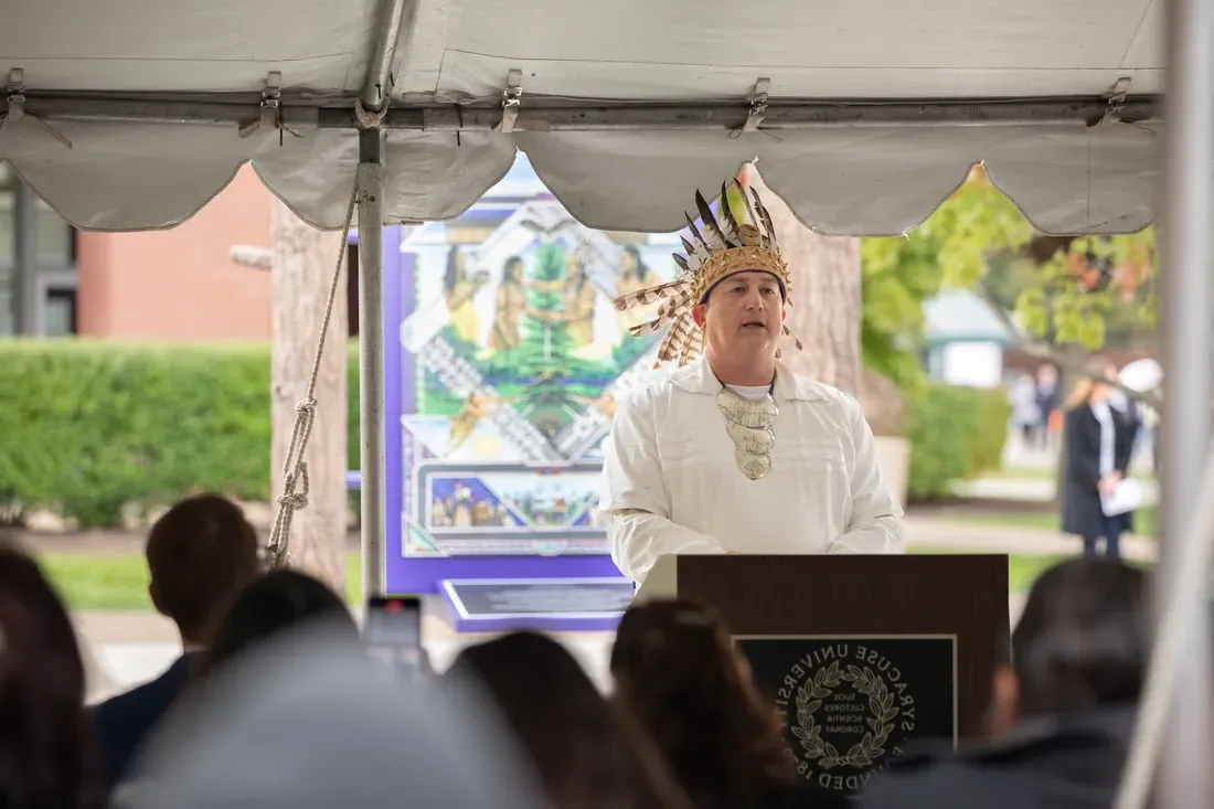 A person talking to a crowd.